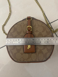 Signature Round Sling Bag